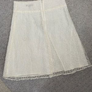 White skirt with lace pattern and lining. Medium size